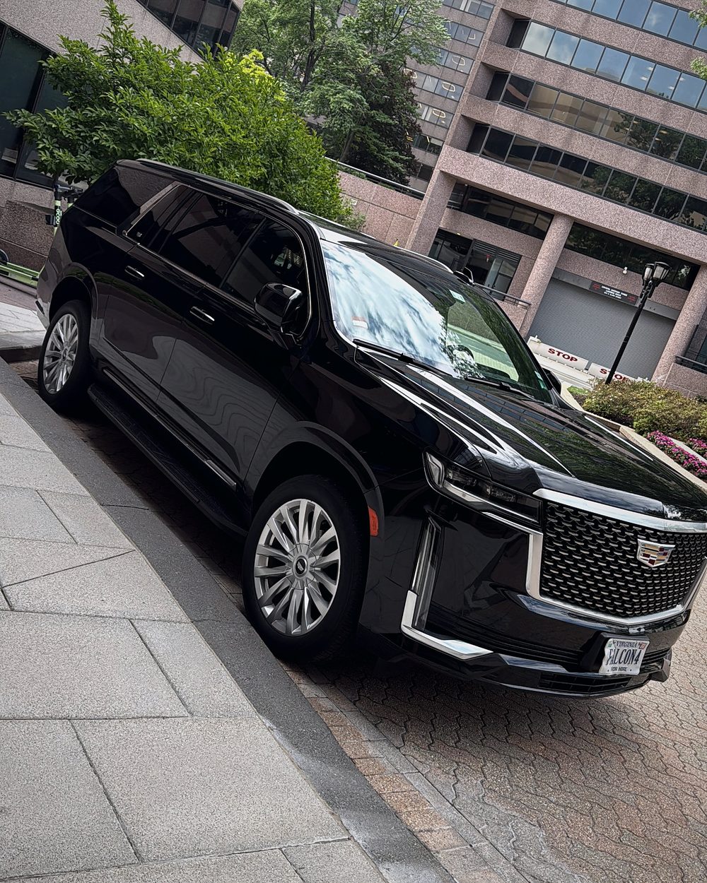Falcon Valet Cadillac Escalade parked outside an office building in Arlington